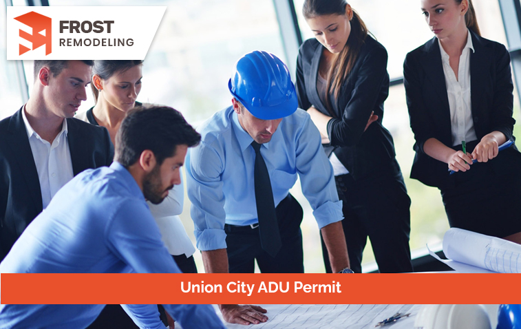 Contractor presenting detailed plans to a team in a construction meeting